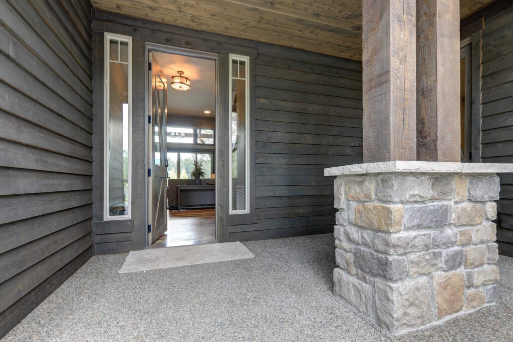 Custom home entry with wood, rock and stone